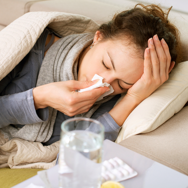 Sick Woman. Flu. Woman Caught Cold. Sneezing into Tissue
